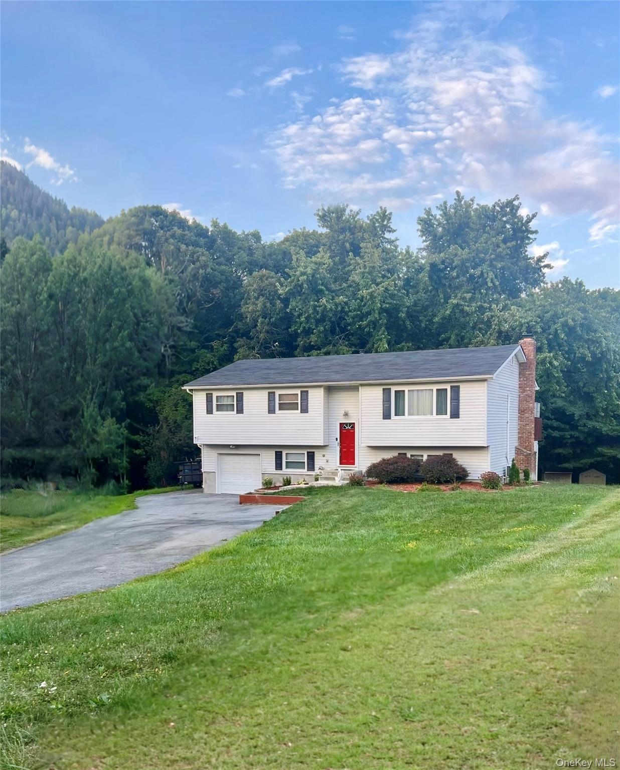 a house with green field in front of it