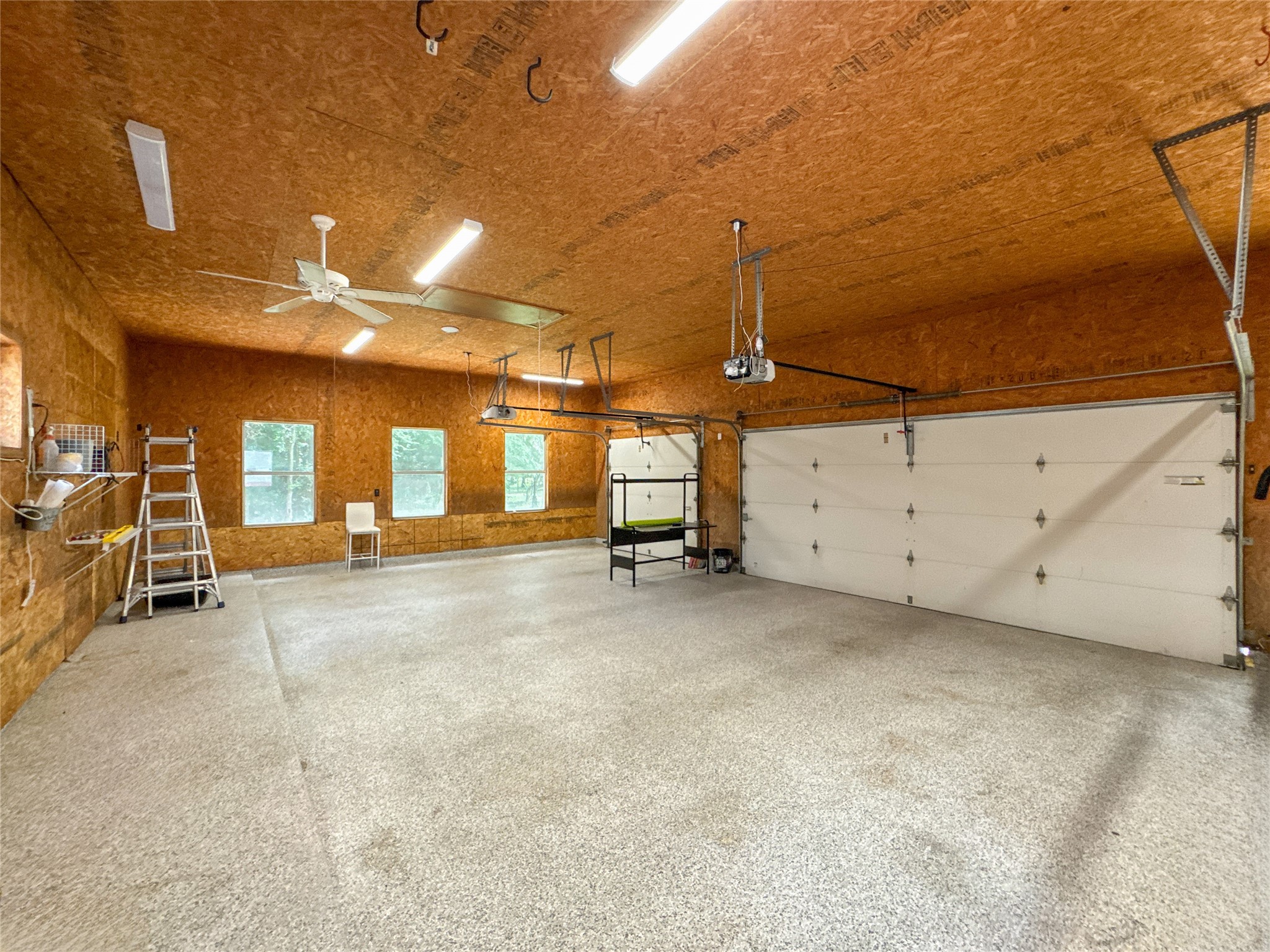 1810 Woerner Road Houston, TX 77090 - Photo 39 of 39 Spacious, well-lit garage with ample storage and workspace potential, perfect for vehicles and projects.