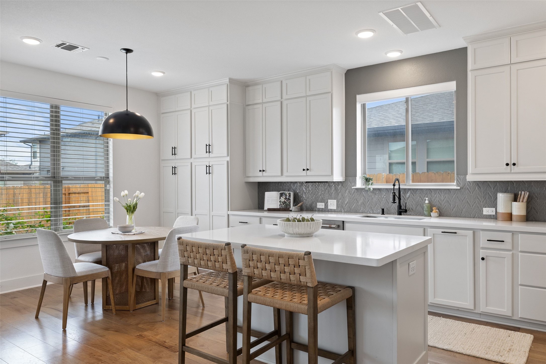 7908 Yokohama Terrace Austin, TX 78744 - Photo 15 of 40 a kitchen with kitchen island granite countertop a table chairs sink and cabinets