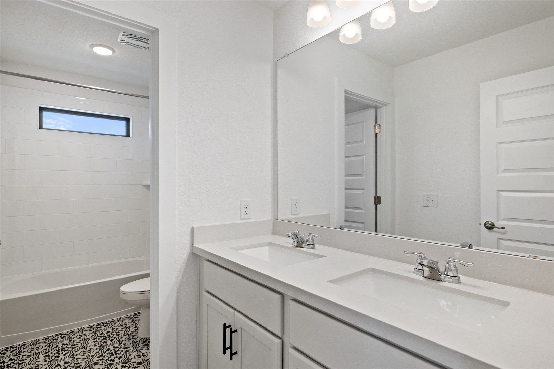 7908 Yokohama Terrace Austin, TX 78744 - Photo 30 of 40 a bathroom with a shower sink vanity and a mirror