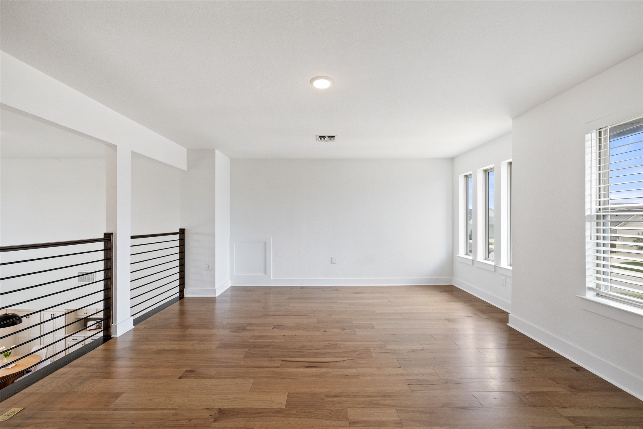 7908 Yokohama Terrace Austin, TX 78744 - Photo 32 of 40 a view of an empty room with wooden floor and a window