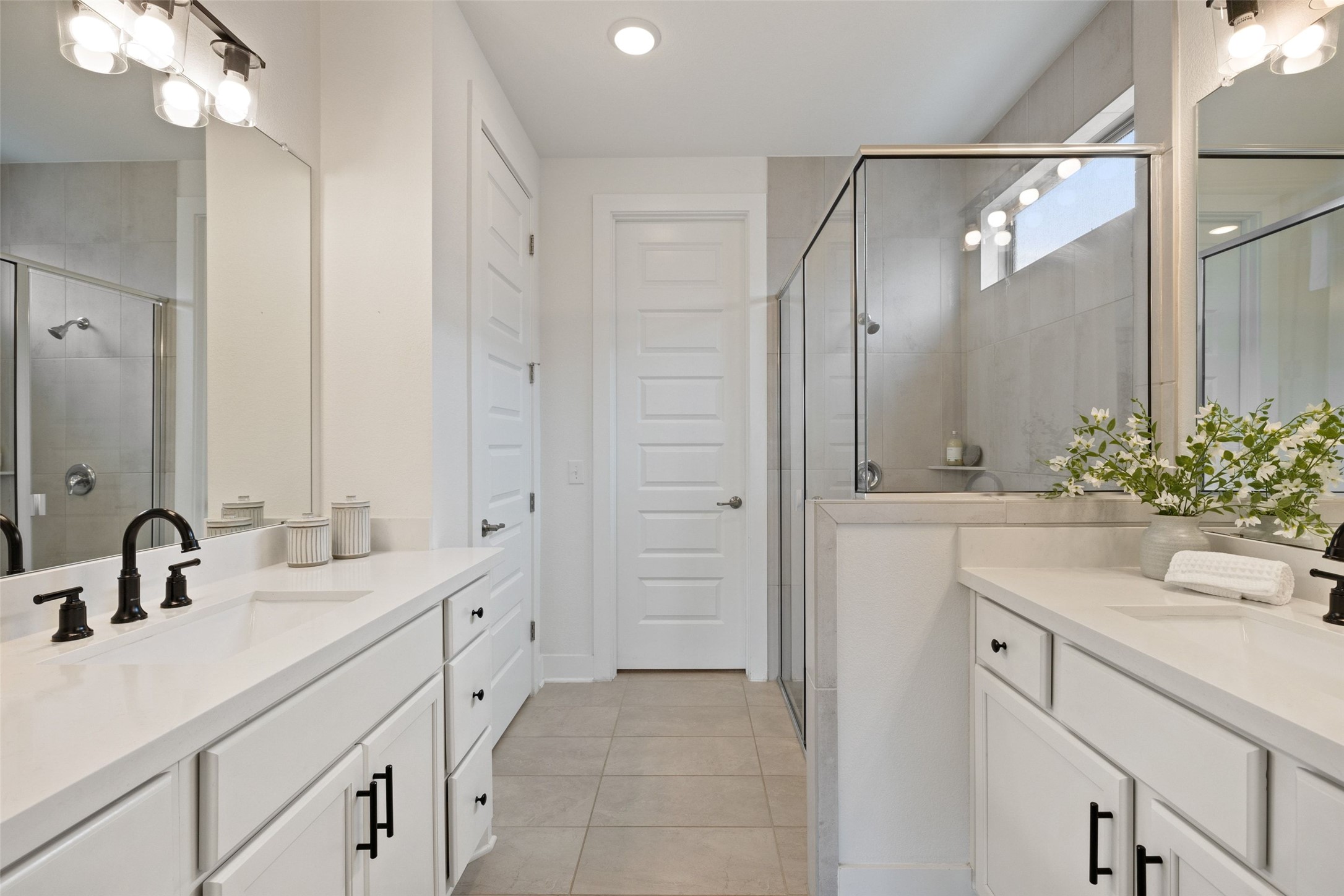 7908 Yokohama Terrace Austin, TX 78744 - Photo 6 of 40 a bathroom with a double vanity sink mirror and shower