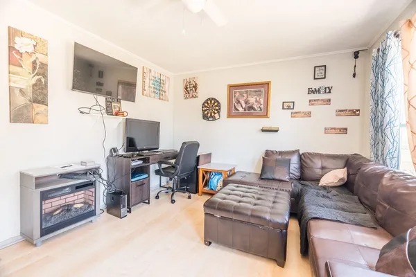 a living room with furniture and a flat screen tv