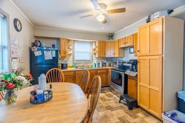 a kitchen with a refrigerator and a stove
