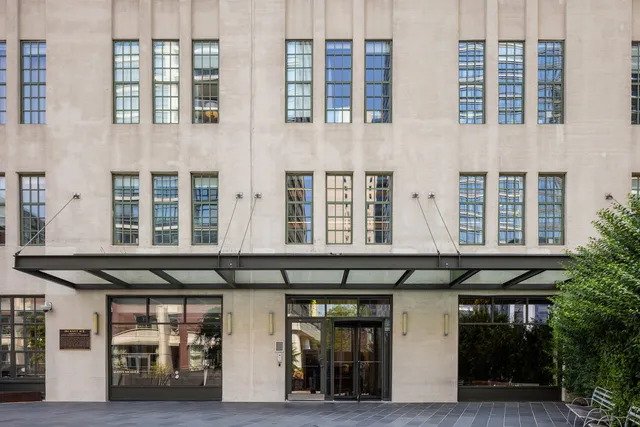 a view of a patio with couches table and chairs and potted plants
