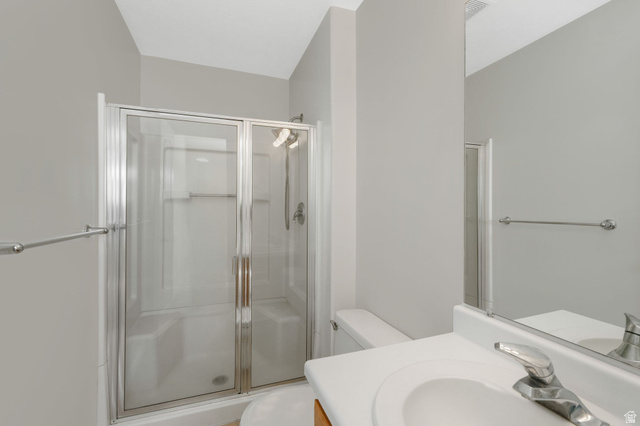 7936 Wycliffe Way Eagle Mountain, UT 84005 - Photo 13 of 37 Primary Full bathroom featuring vanity and a stall shower