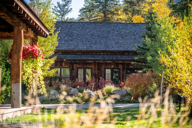 a view of a brick house with a tree