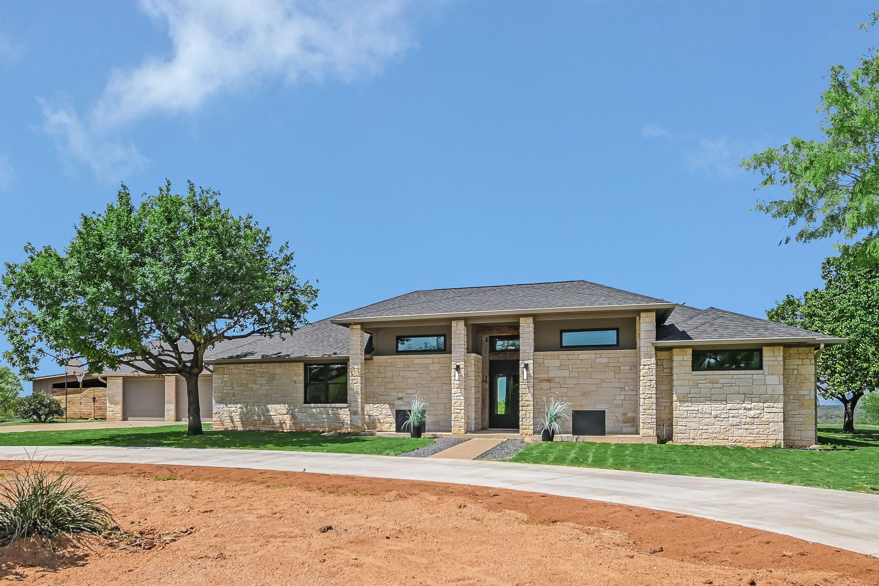 418 The Hills Road Horseshoe Bay, TX 78657 - Photo 1 of 1 a front view of a house with a yard