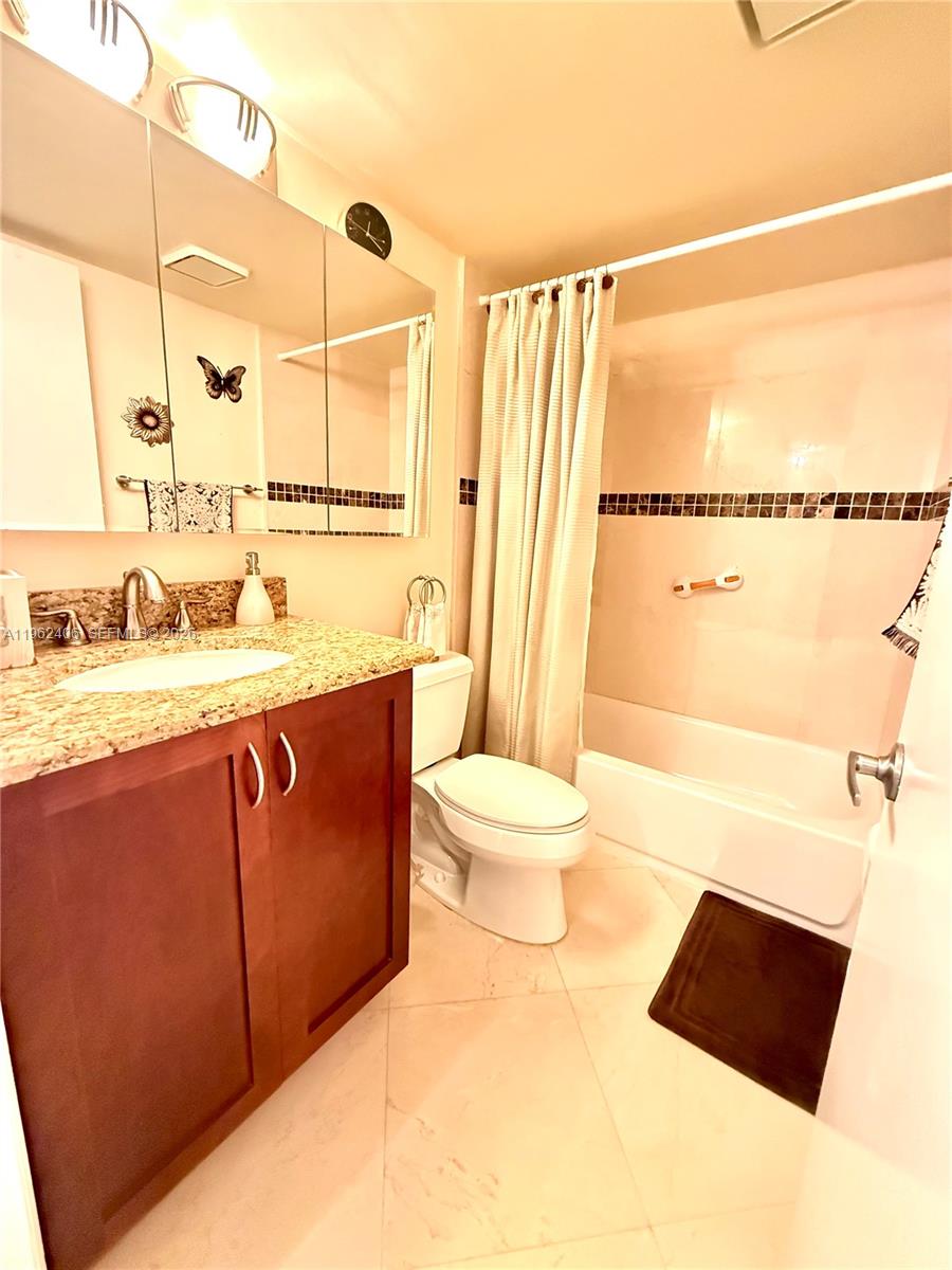 351 Club Circle, Unit 102 Boca Raton, FL 33487 - Photo 21 of 34 a bathroom with a sink a toilet and shower