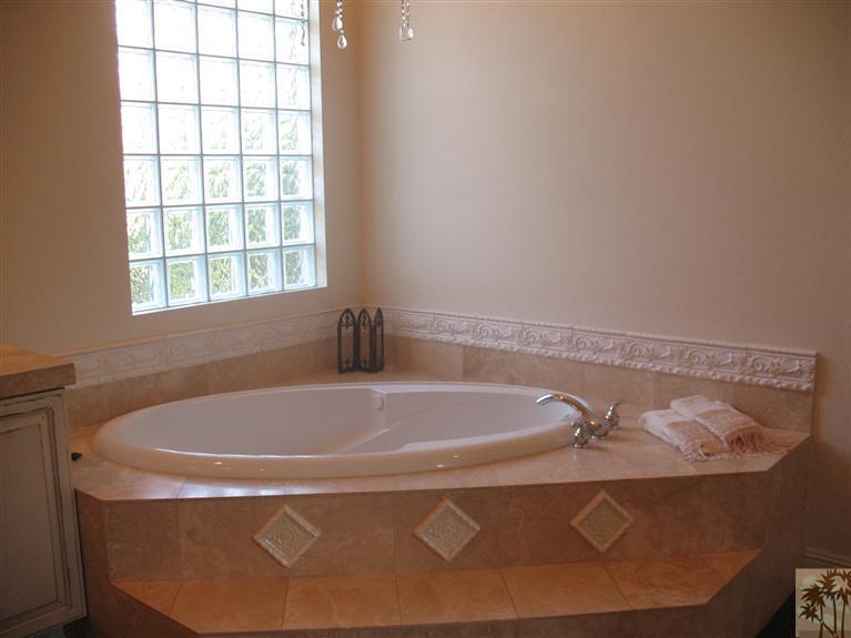 6 Varsity Circle Rancho Mirage, CA 92270 - Photo 11 of 21 a bath tub sitting in a bathroom next to a window