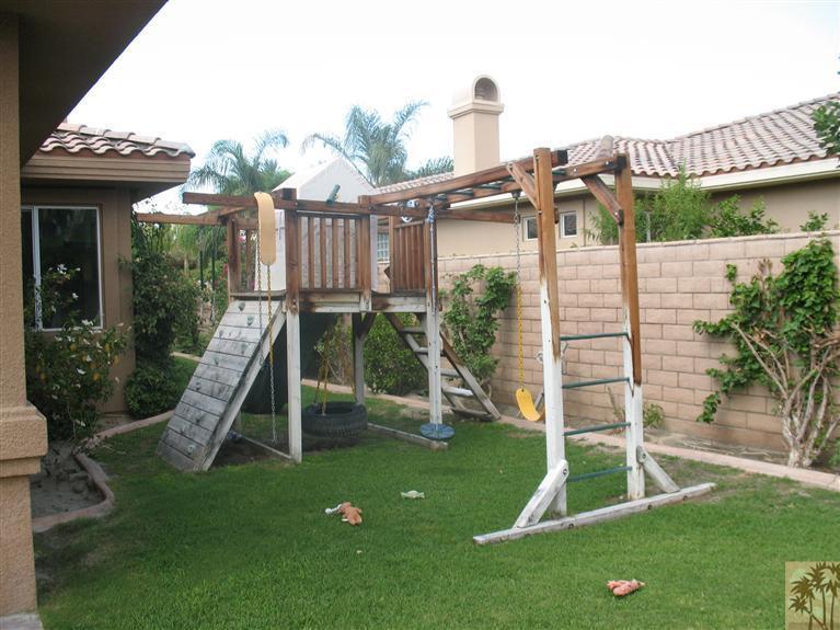 6 Varsity Circle Rancho Mirage, CA 92270 - Photo 14 of 21 a view of a house with a backyard