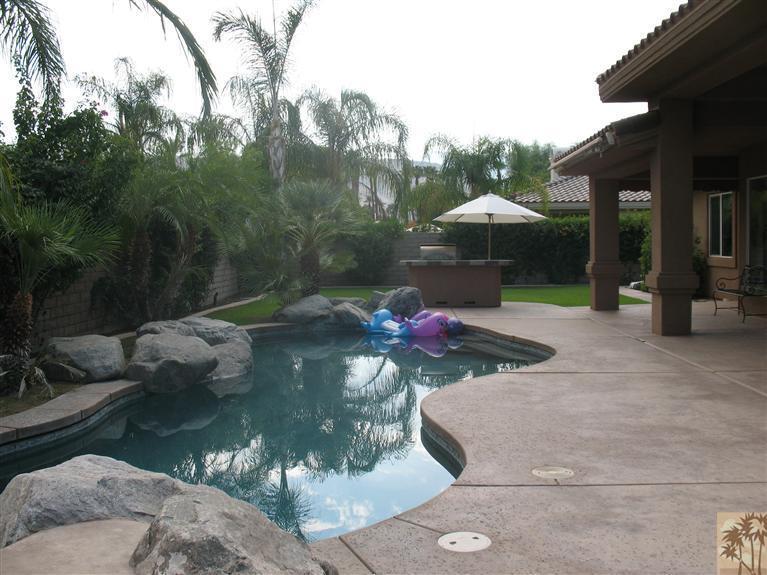 6 Varsity Circle Rancho Mirage, CA 92270 - Photo 15 of 21 a view of a lake in the backyard