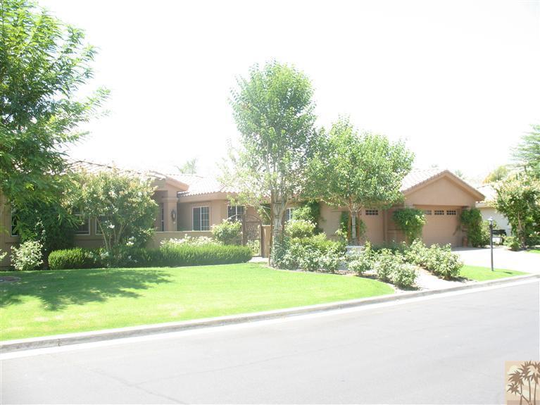 6 Varsity Circle Rancho Mirage, CA 92270 - Photo 19 of 21 a front view of a house with a yard and garage