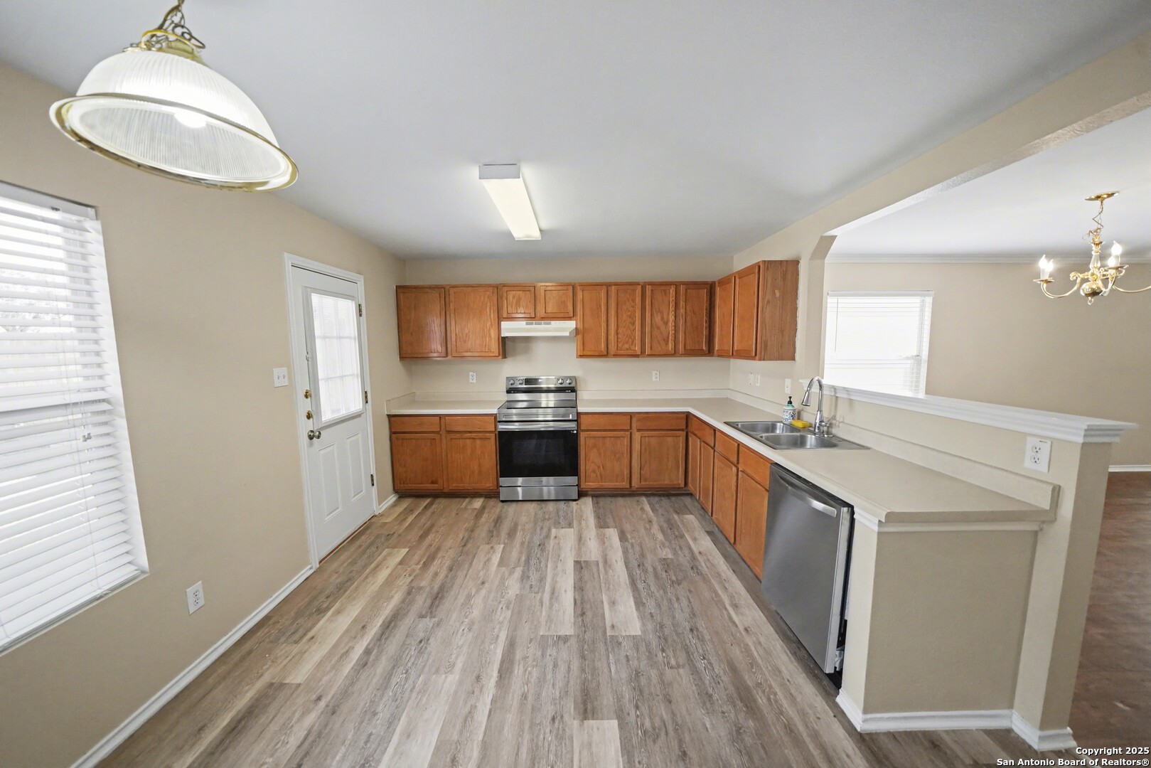 112 Stream Crossing Cibolo, TX 78108 - Photo 11 of 38 a large kitchen with a lot of counter space and wooden floor