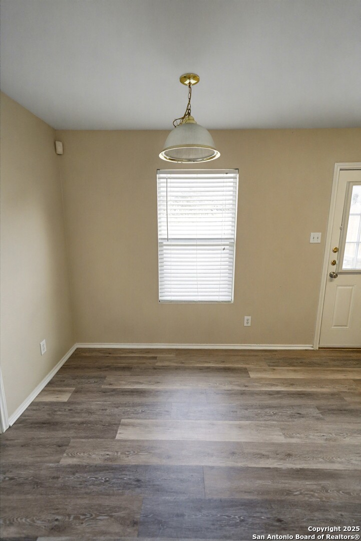 112 Stream Crossing Cibolo, TX 78108 - Photo 16 of 38 a view of an empty room with wooden floor and a window