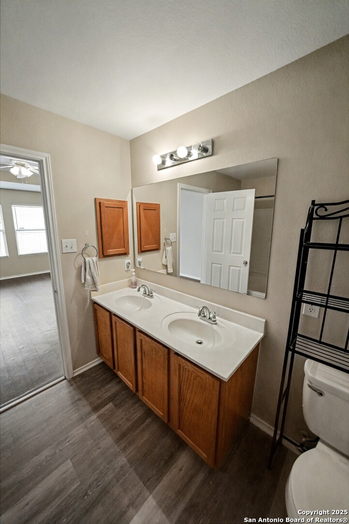 112 Stream Crossing Cibolo, TX 78108 - Photo 23 of 38 a kitchen with a sink cabinets and wooden floor