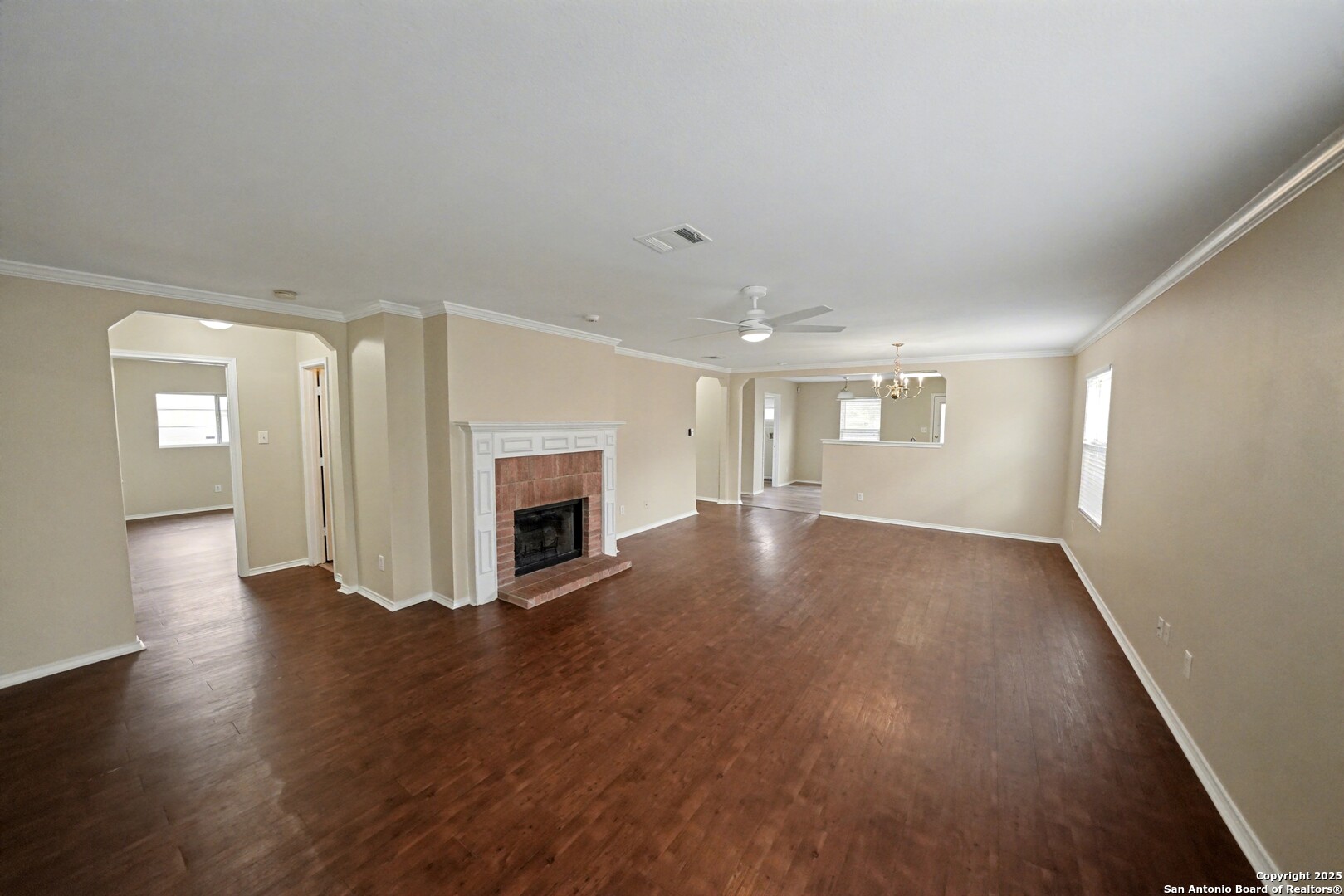 112 Stream Crossing Cibolo, TX 78108 - Photo 7 of 38 an empty room with wooden floor fireplace and windows