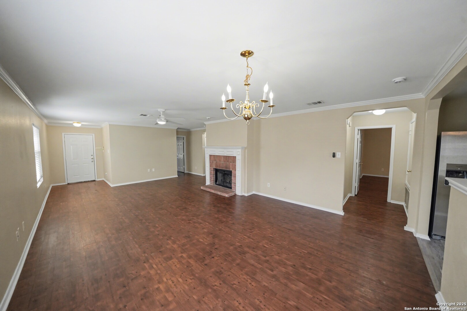 112 Stream Crossing Cibolo, TX 78108 - Photo 10 of 38 a view of a livingroom with a fireplace a chandelier and wooden floor