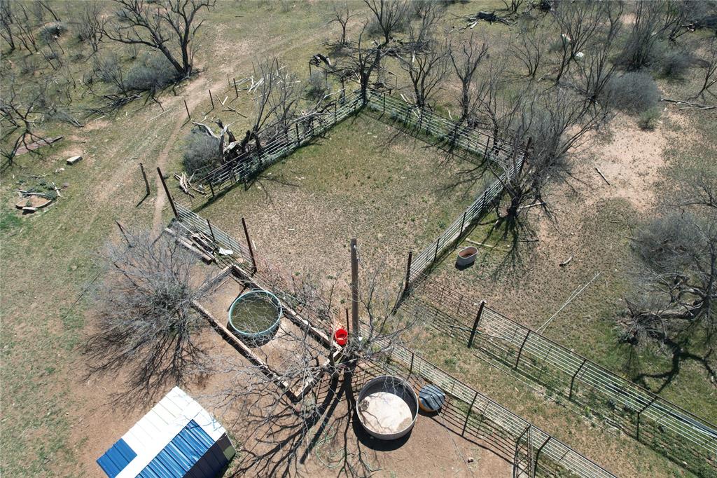 409 Merkel Tx 79536 Merkel, TX 79536 - Photo 10 of 24 a view of a backyard with plants and wooden fence