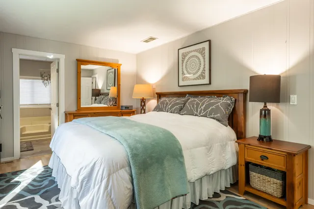 a bedroom with a bed and a dresser