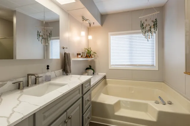 a bedroom with a bed and large windows