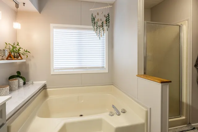 a bathroom with a tub sink and mirror