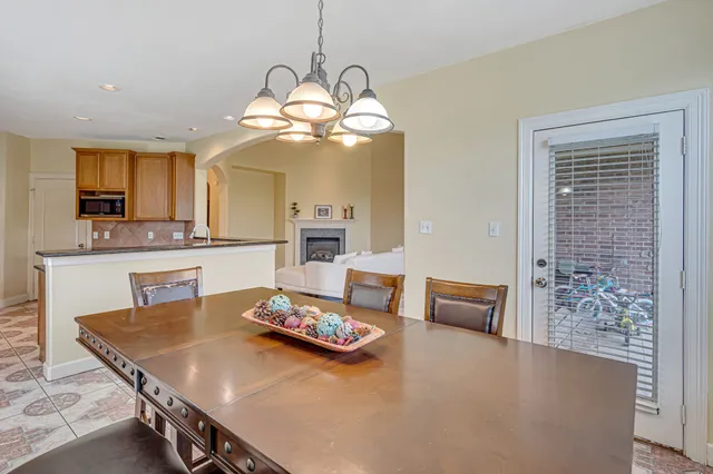 a living room with dining table and chairs