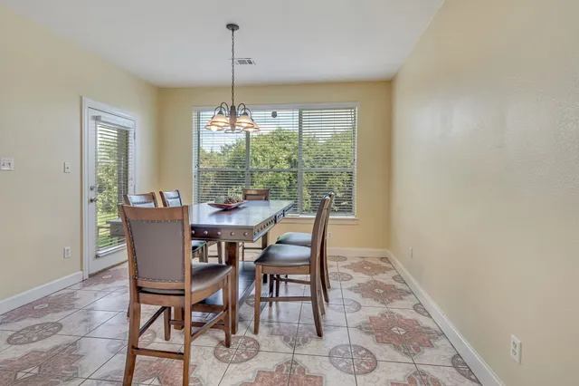 a dining room with furniture window and outside view