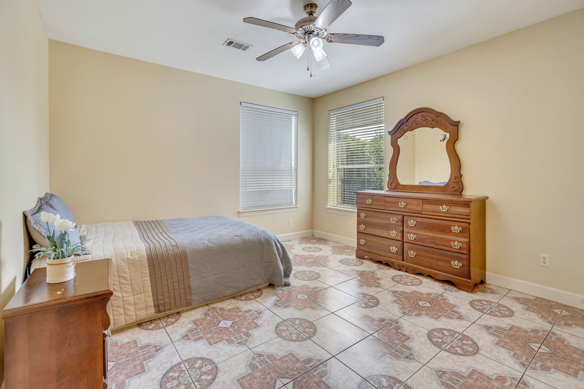 4810 Plum Forest Road Houston, TX 77084 - Photo 16 of 29 a bedroom with a bed and a dresser