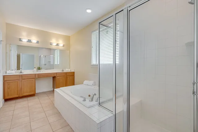 a bathroom with a tub sink and mirror
