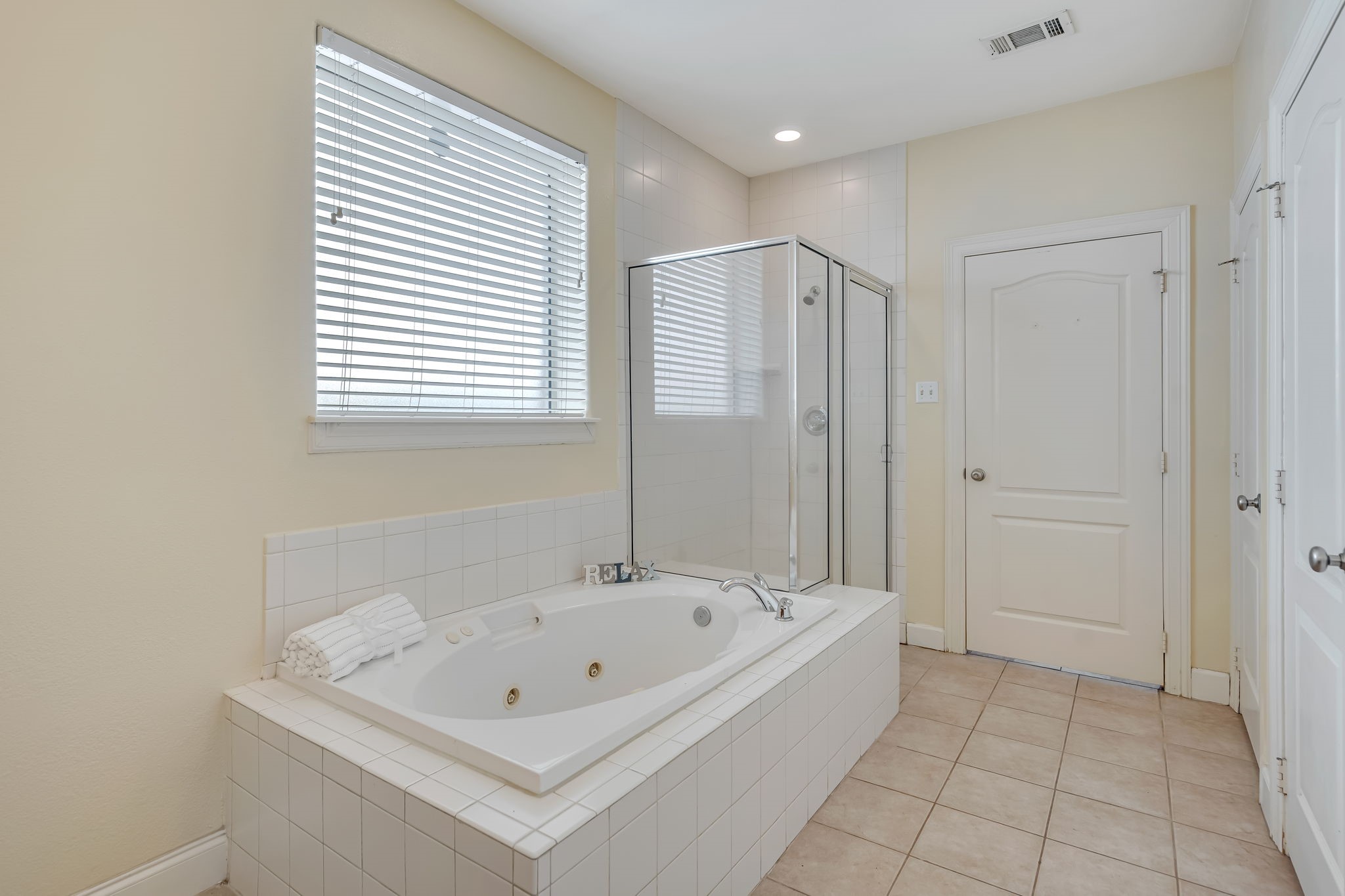 4810 Plum Forest Road Houston, TX 77084 - Photo 18 of 29 a white bath tub sitting in a bathroom next to a window