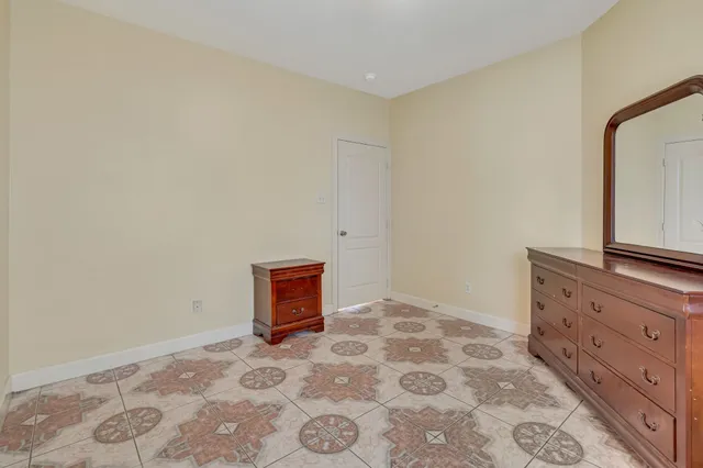 a bedroom with a bed and a dresser in it