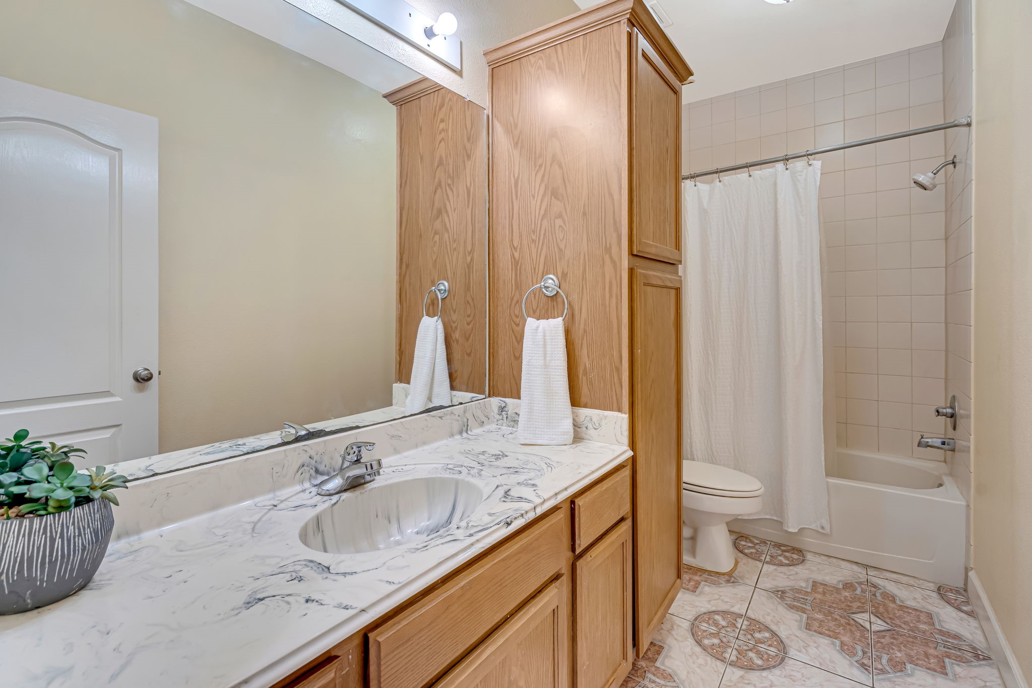 4810 Plum Forest Road Houston, TX 77084 - Photo 23 of 29 a bathroom with a granite countertop sink a toilet and shower