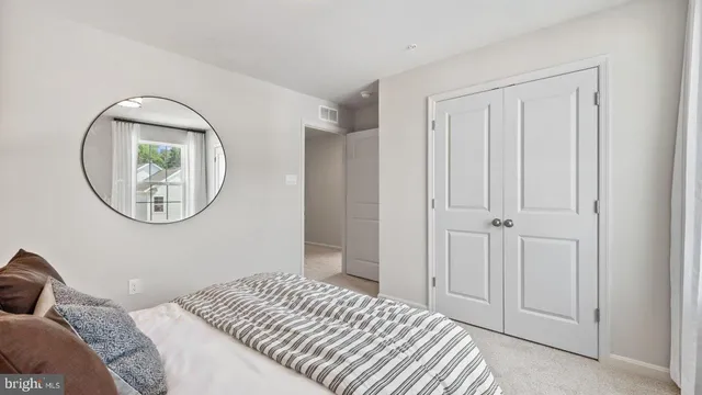 a bedroom with a large bed and a window