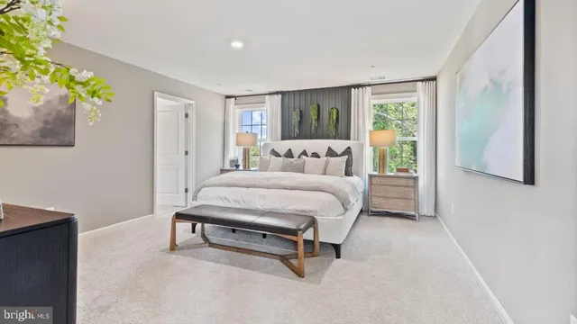 a bedroom with a bed and painting on the wall