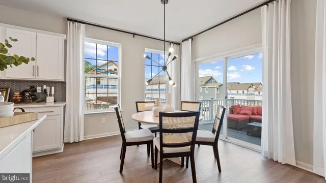 a living room with furniture and large windows