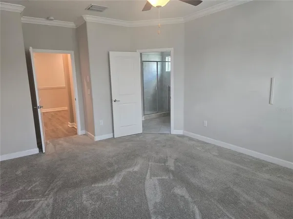 a view of an empty room with wooden floor