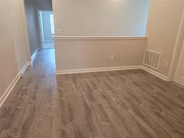 an empty room with closet and mirror