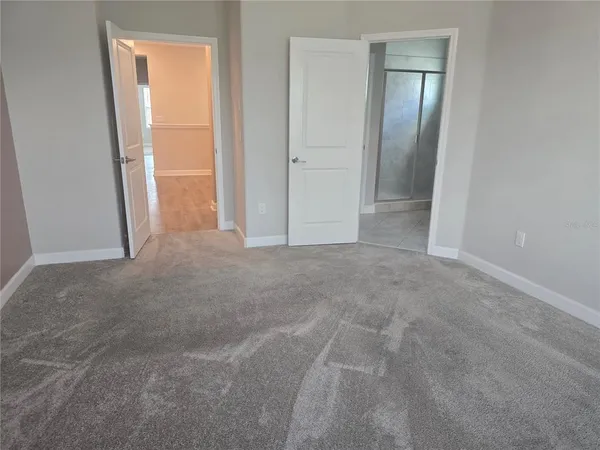 a bathroom with a granite countertop sink a mirror and shower