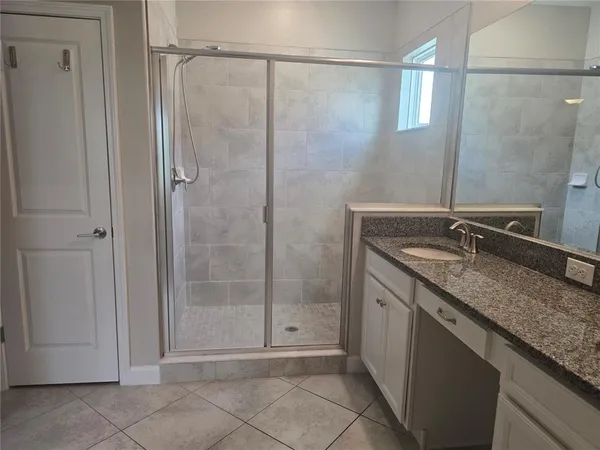 a bathroom with a granite countertop sink a mirror and a