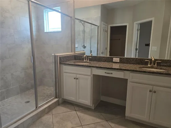 a kitchen with kitchen island granite countertop a sink a counter top space appliances and cabinets