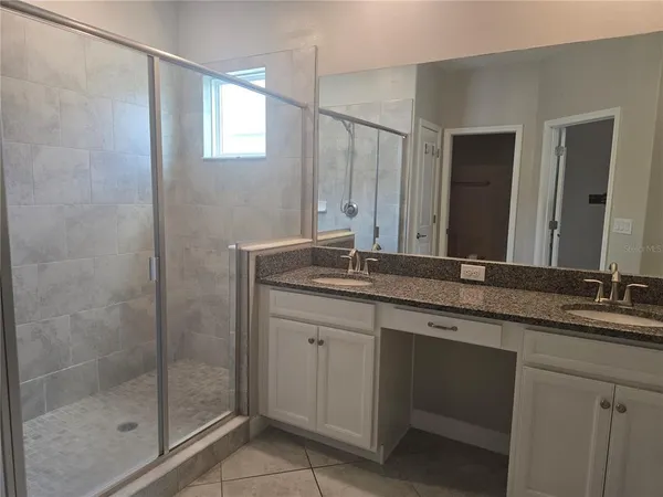 a kitchen with kitchen island granite countertop a sink appliances and cabinets