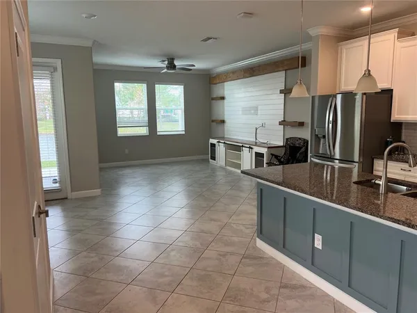a kitchen with stainless steel appliances a sink stove and refrigerator