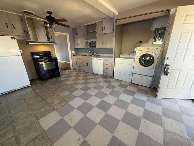 a kitchen with a sink a stove and cabinets