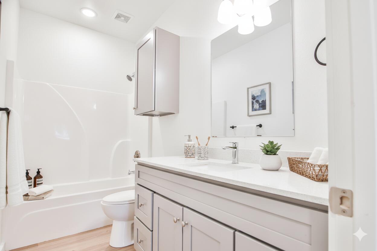 5506 Itasca Street Lubbock, TX 79416 - Photo 7 of 15 a bathroom with a sink a toilet and a bathtub