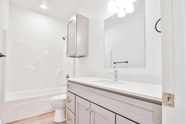 a bathroom with a sink a toilet and bathtub