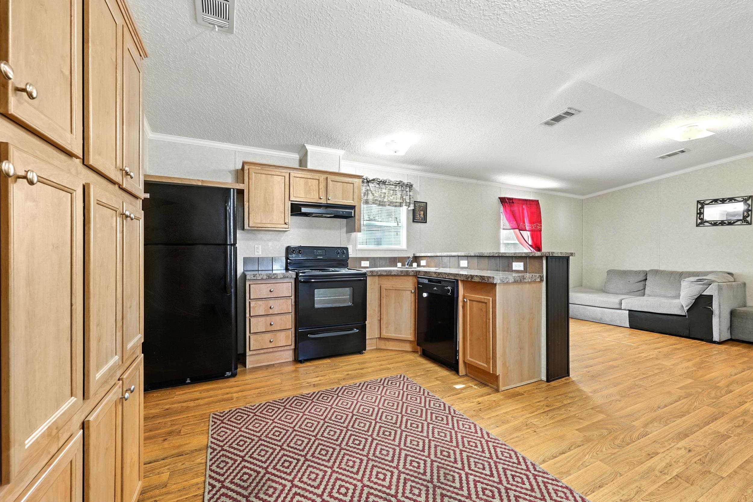 300 East Carter Street Hastings, FL 32145 - Photo 12 of 41 a kitchen with stainless steel appliances granite countertop a refrigerator and a sink