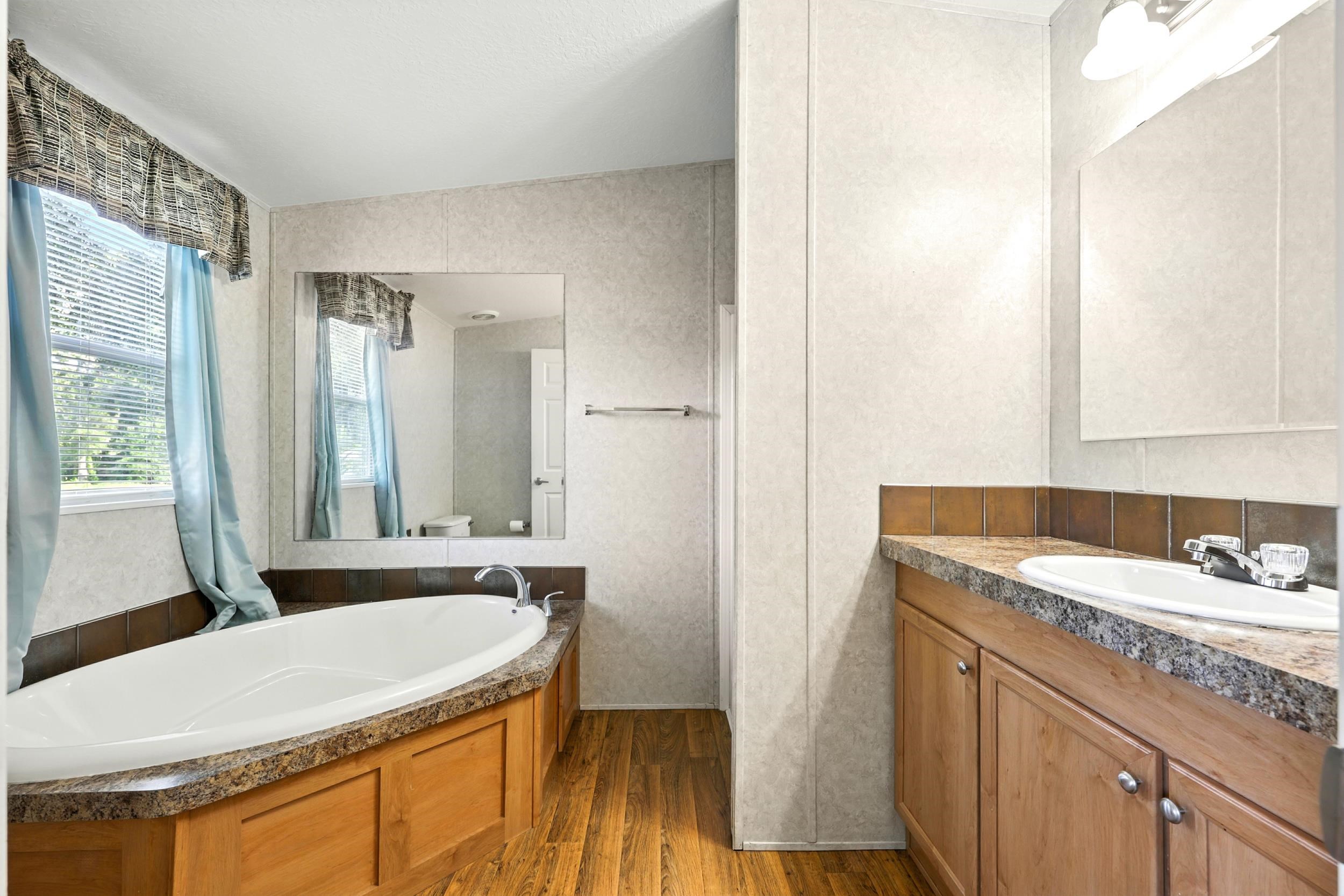 300 East Carter Street Hastings, FL 32145 - Photo 18 of 41 a bathroom with a granite countertop sink and a mirror