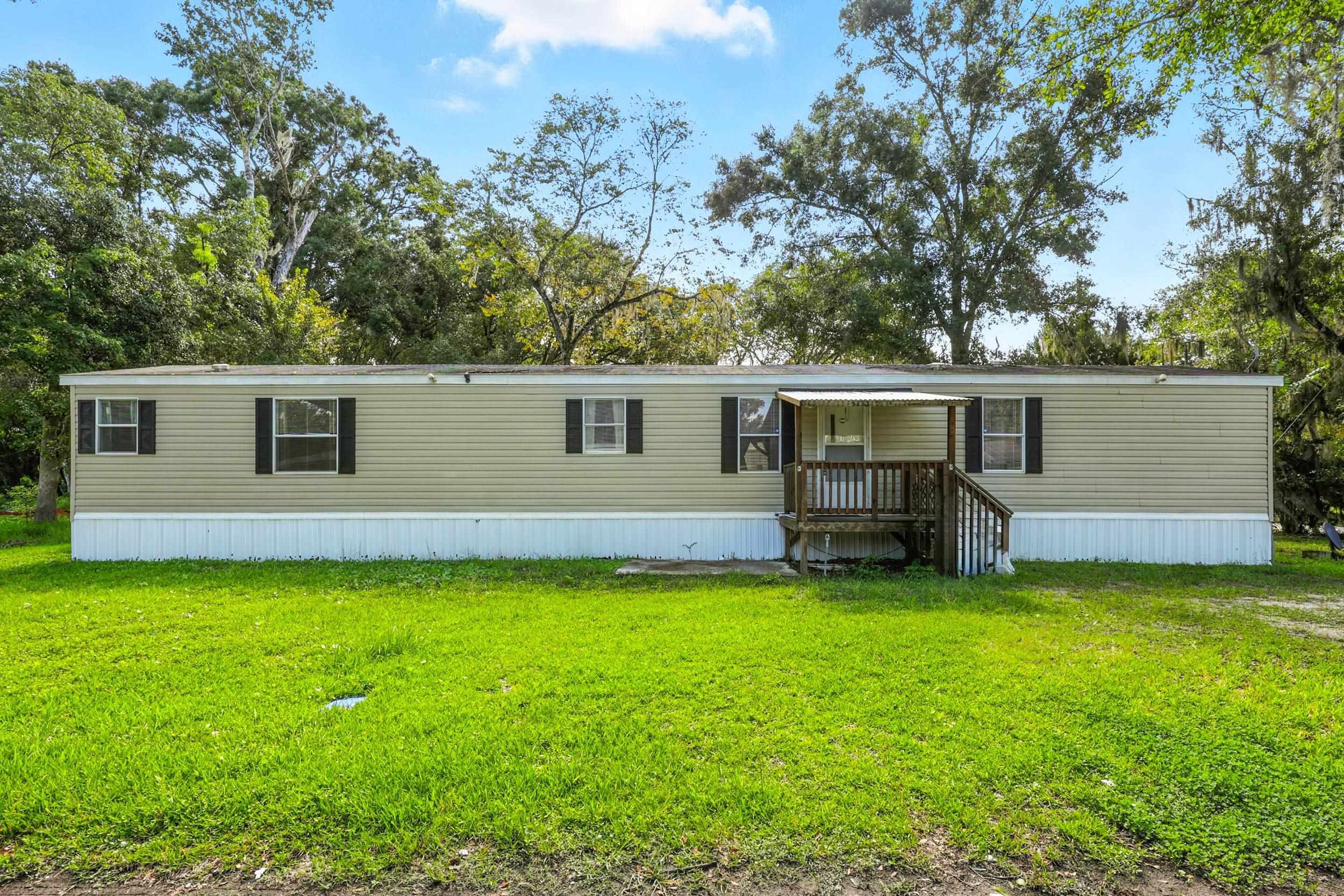 300 East Carter Street Hastings, FL 32145 - Photo 3 of 41 a view of a house with a yard and a tree