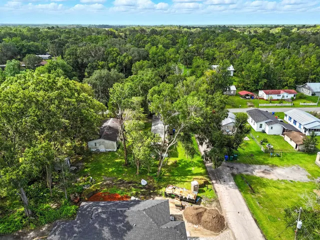 a view of a yard with an umbrella in a garden
